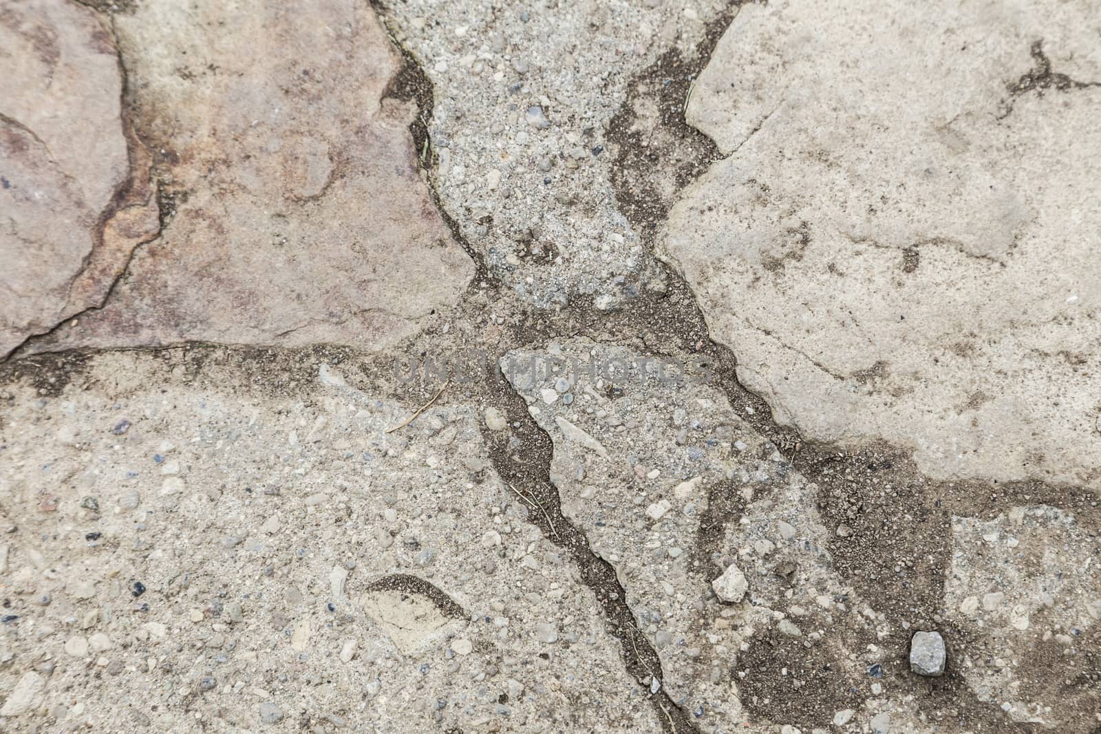 Close shot of a smooth stone wall texture. Cement is used to hold the stones together. 