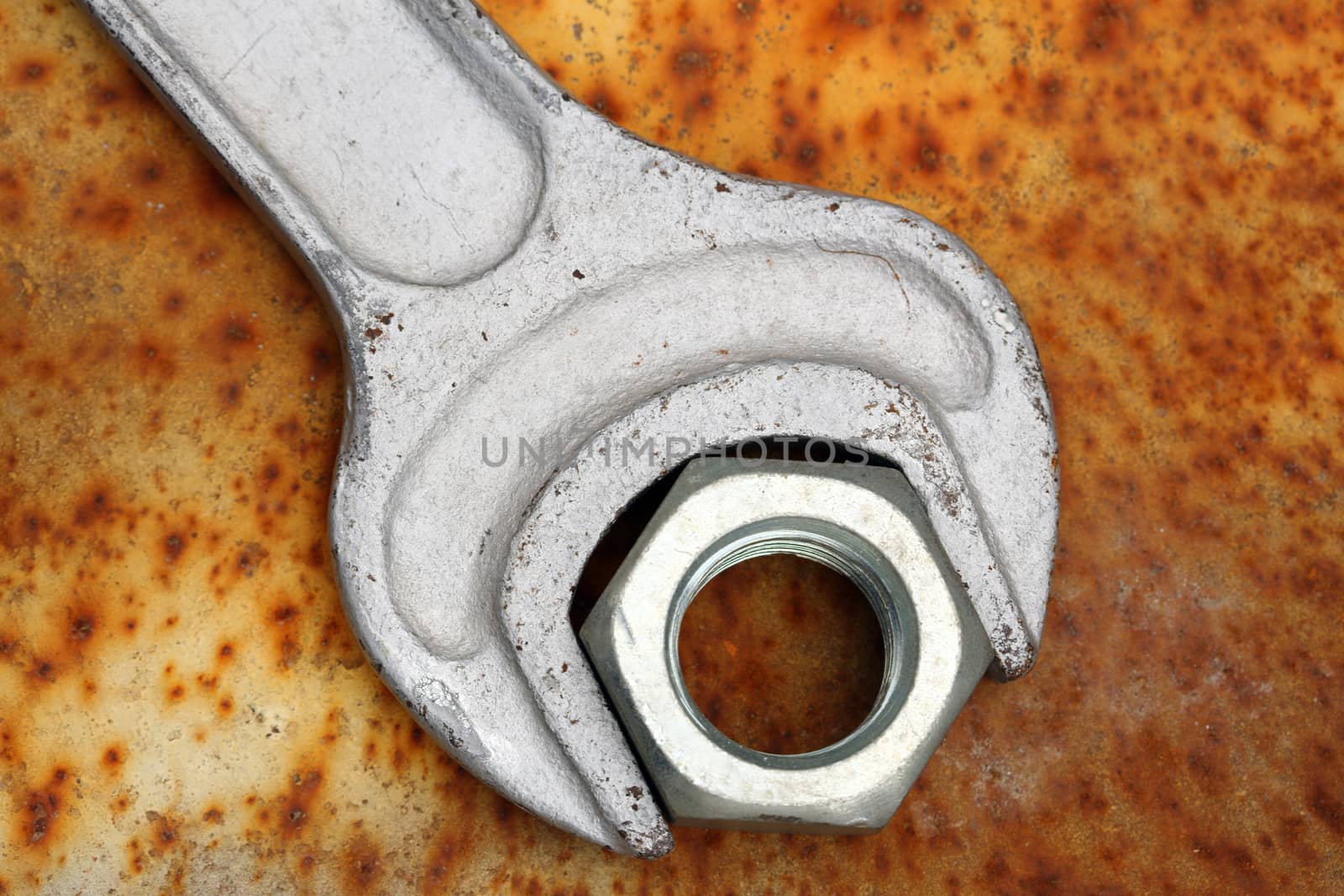 wrench and nut close up on rusty grunge 