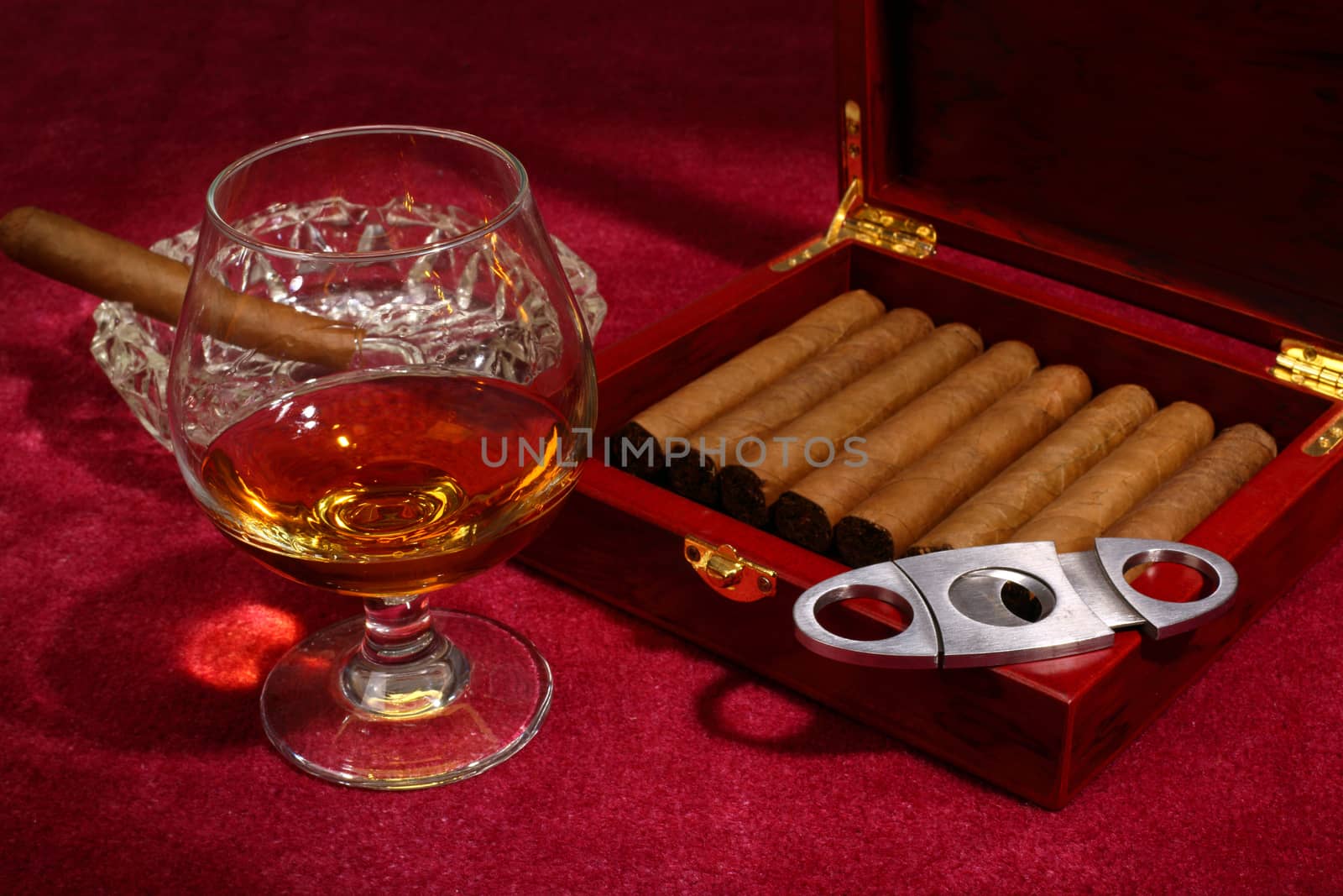 cigars in the box and glass with whisky, close up shallow dof 