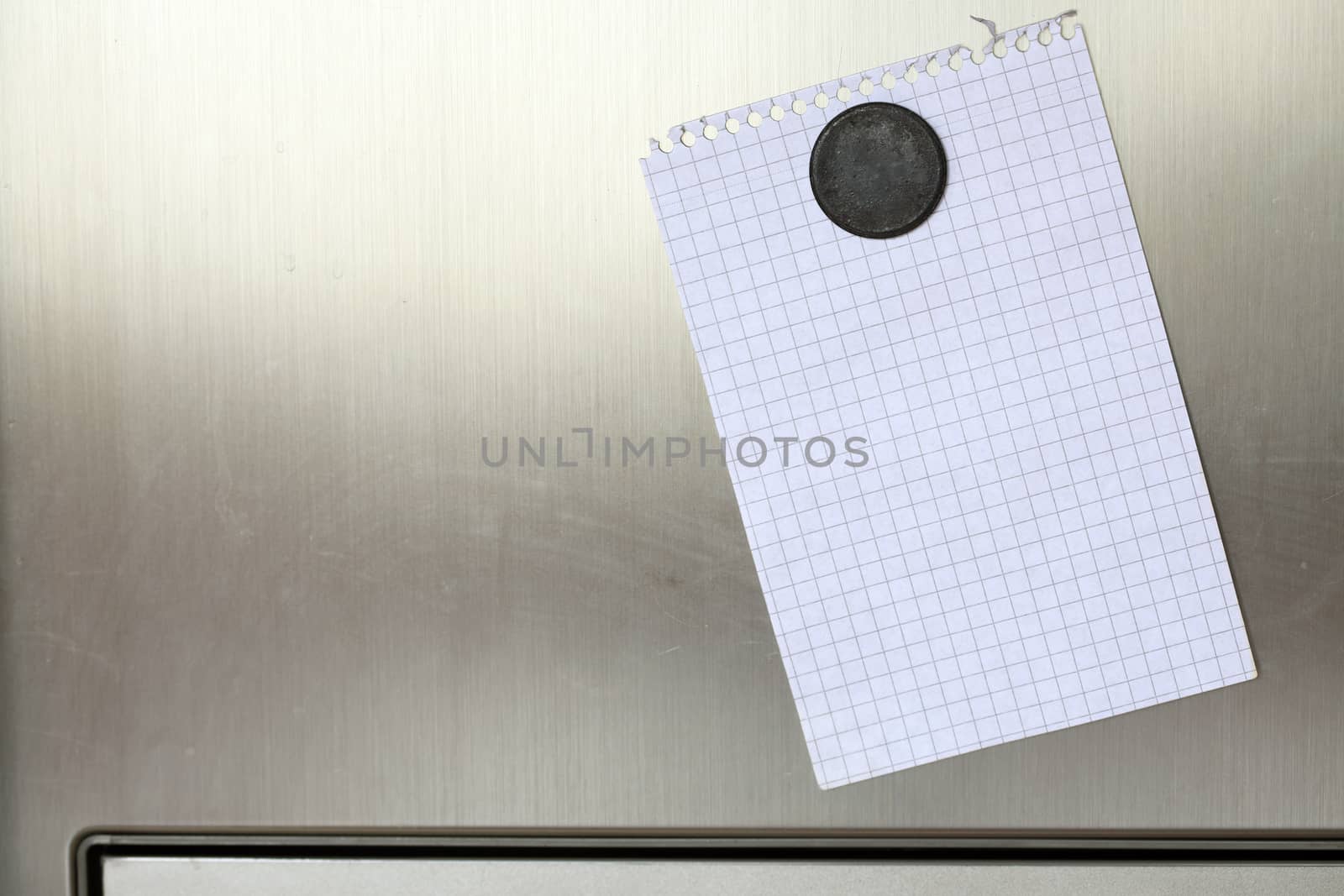 Blank paper and magnet on refrigerator door. 