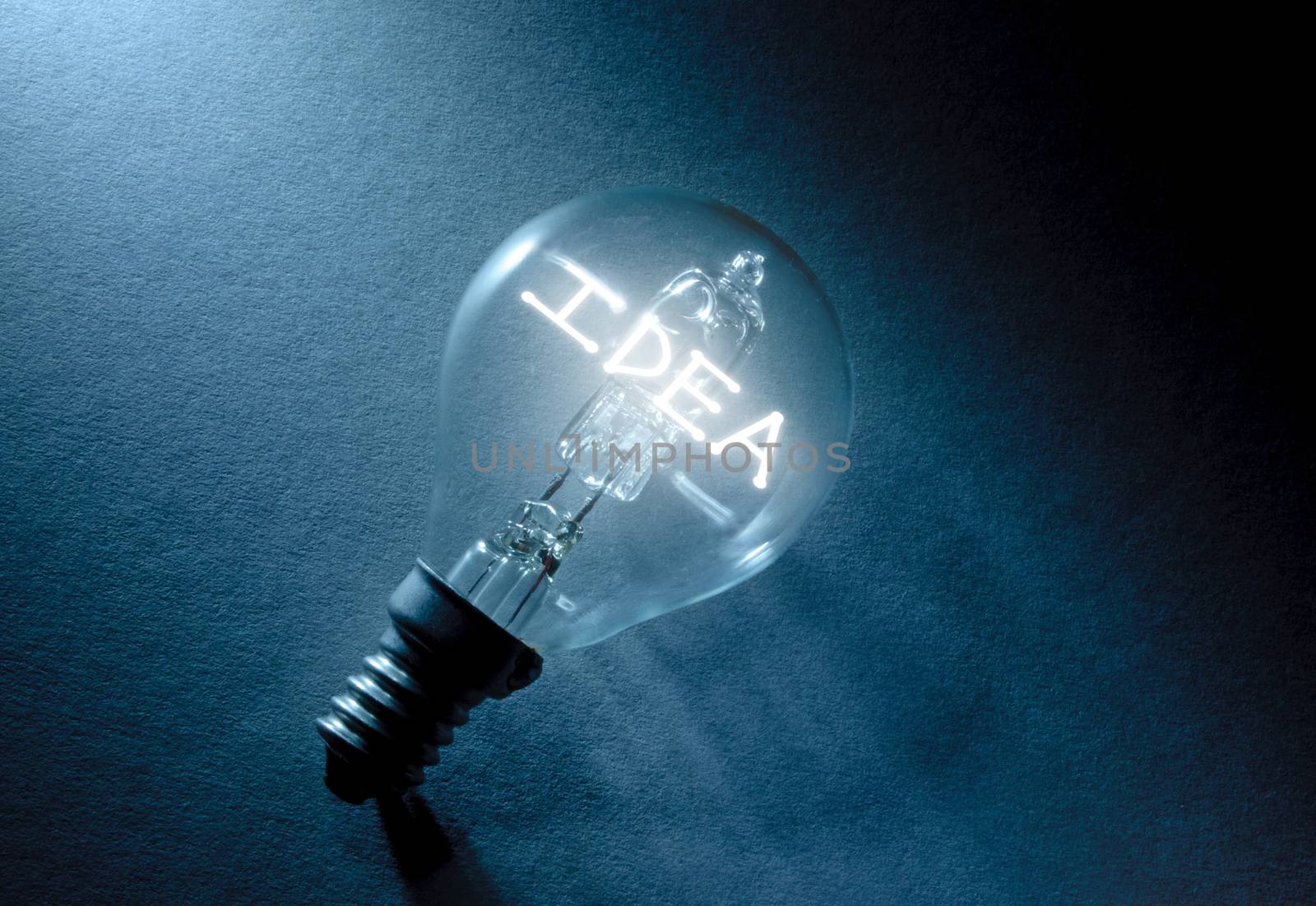 Light bulb illuminating the word idea 
