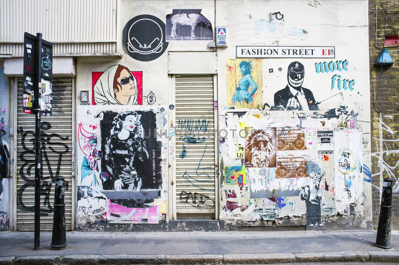 LONDON, UK – APRIL 18, 2014: Graffiti, posters and stickers on Fashion Street, Spitalfields / Whitechapel.