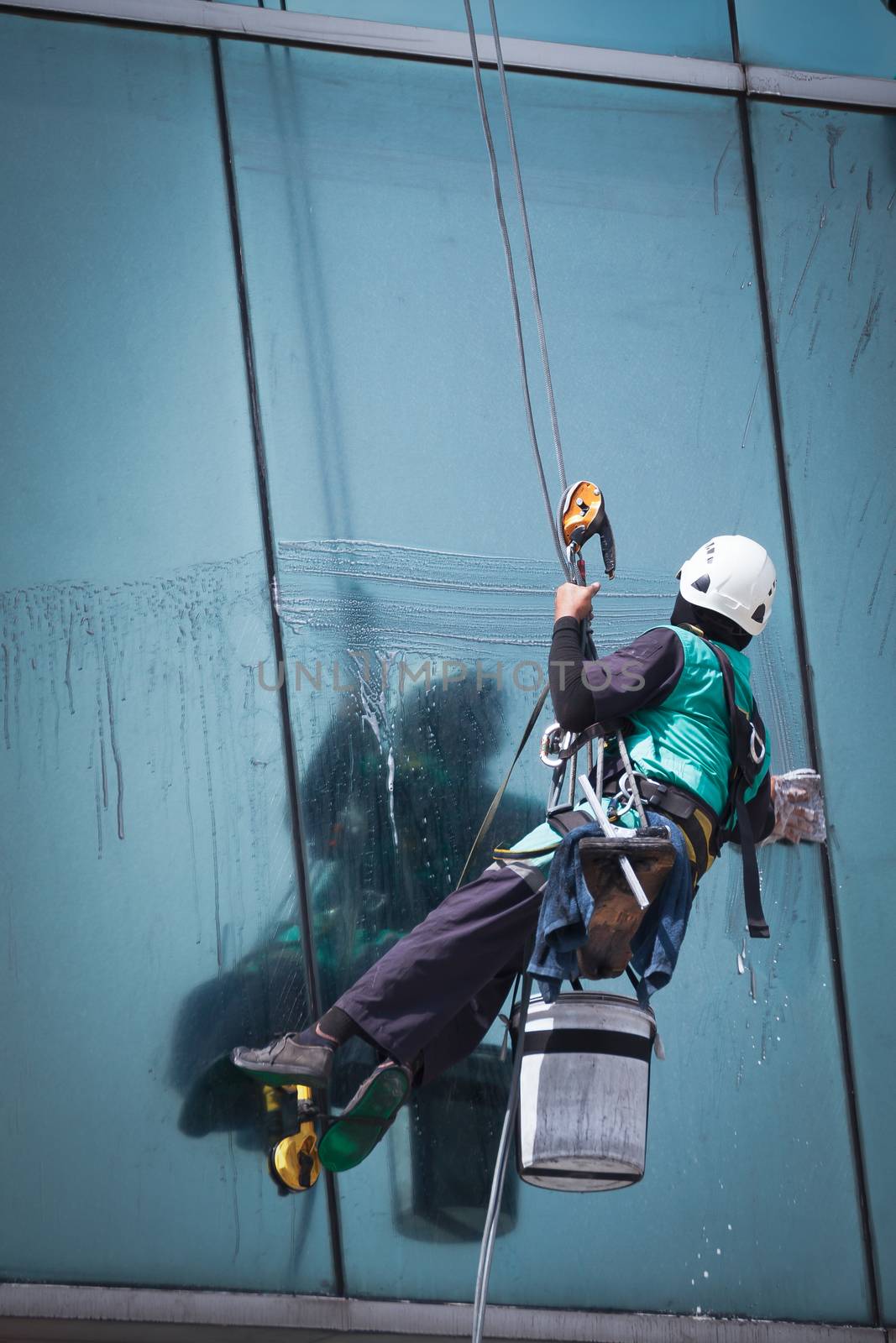 group of workers cleaning windows service on high rise building