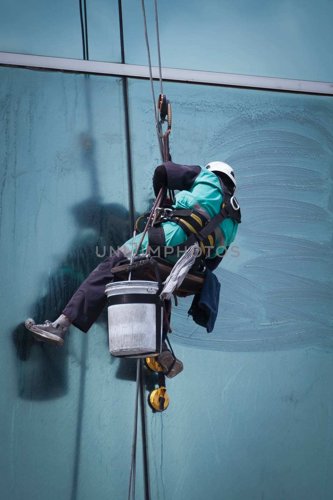 group of workers cleaning windows service on high rise building