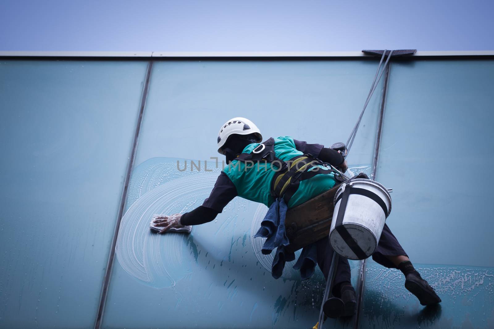 group of workers cleaning windows service on high rise building