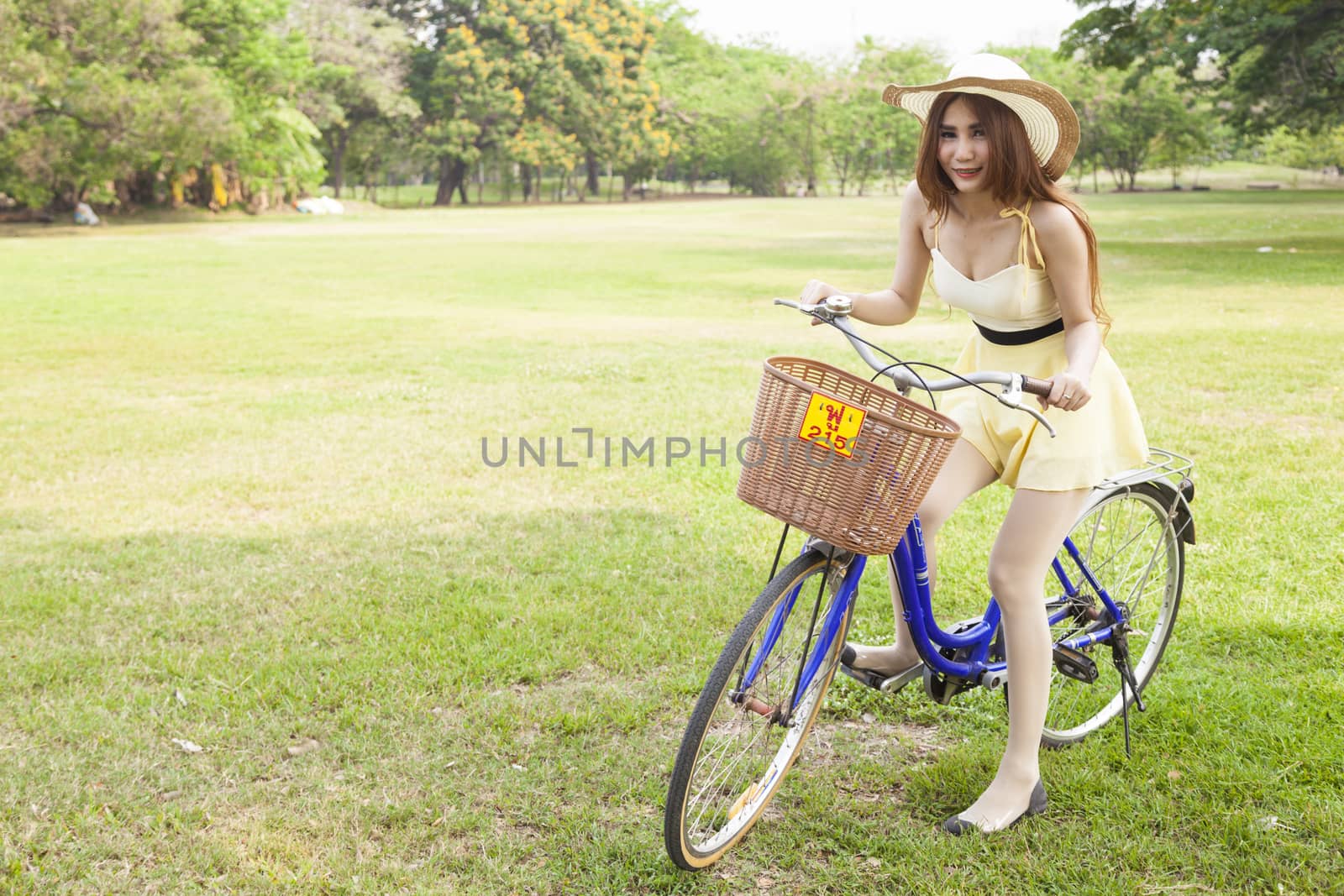 Woman riding a bicycle In the park Trees and peaceful