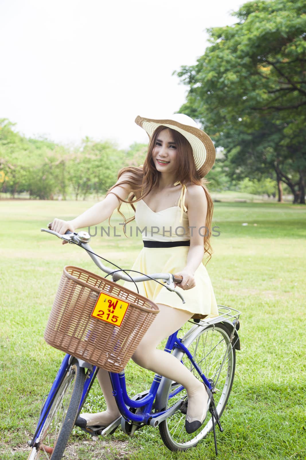 Woman riding a bicycle In the park Trees and peaceful