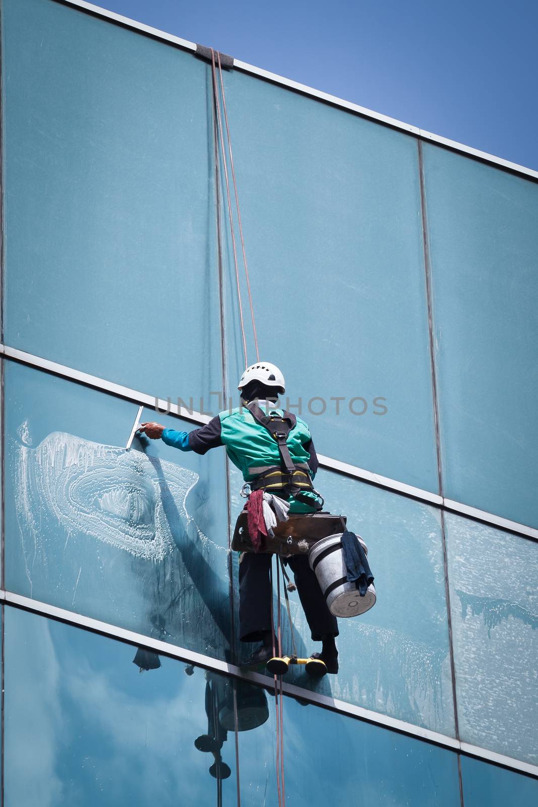 group of workers cleaning windows service on high rise building