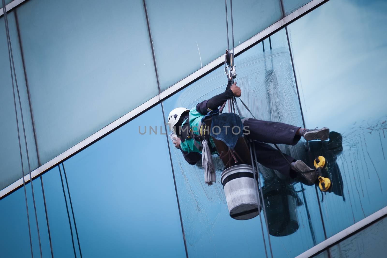 group of workers cleaning windows service on high rise building