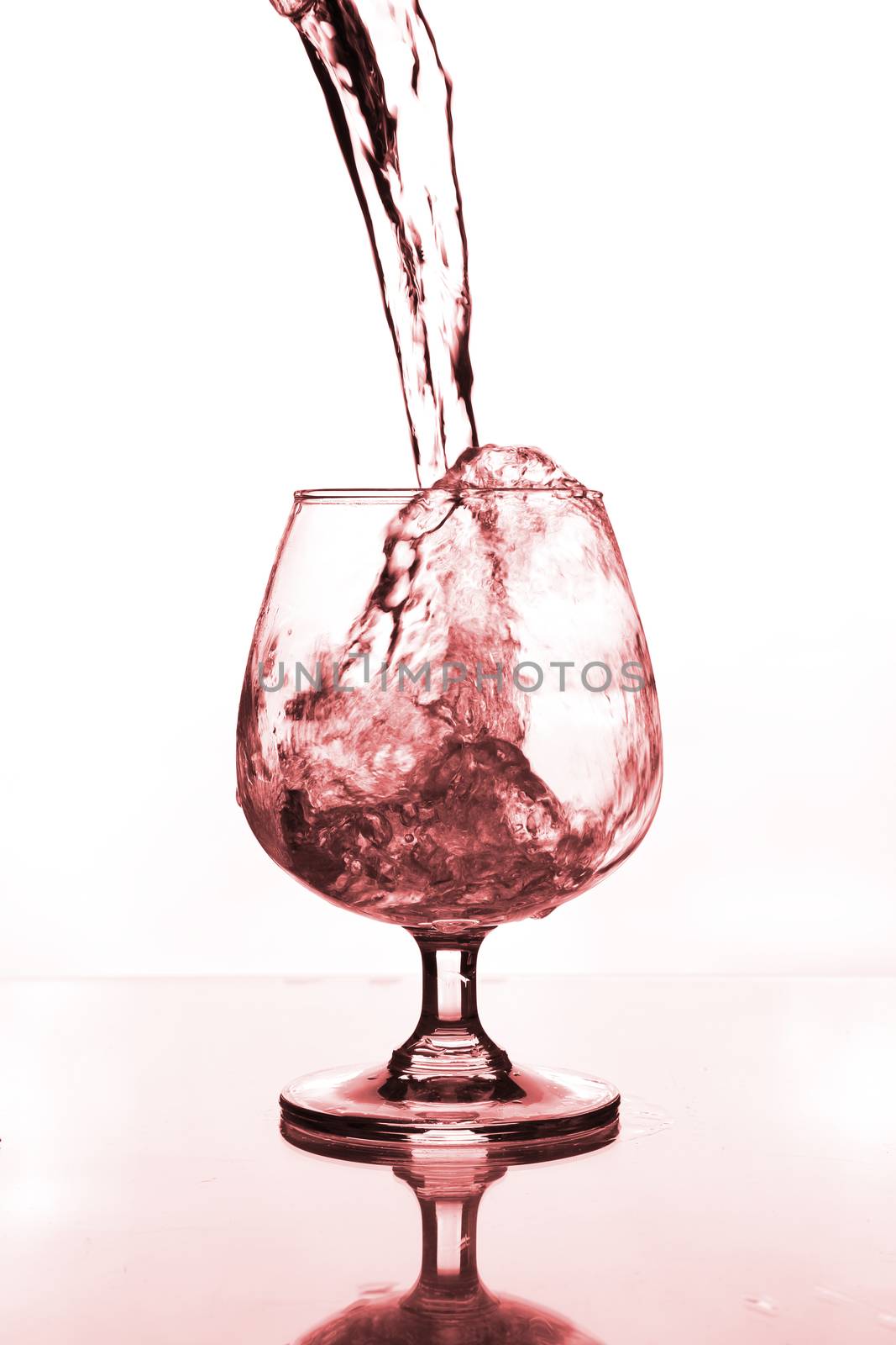wine glass with water pouring on glass table