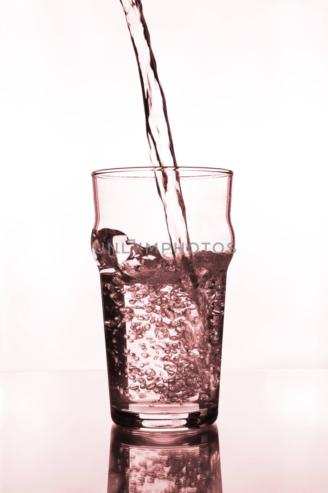 glass with water pouring on glass table