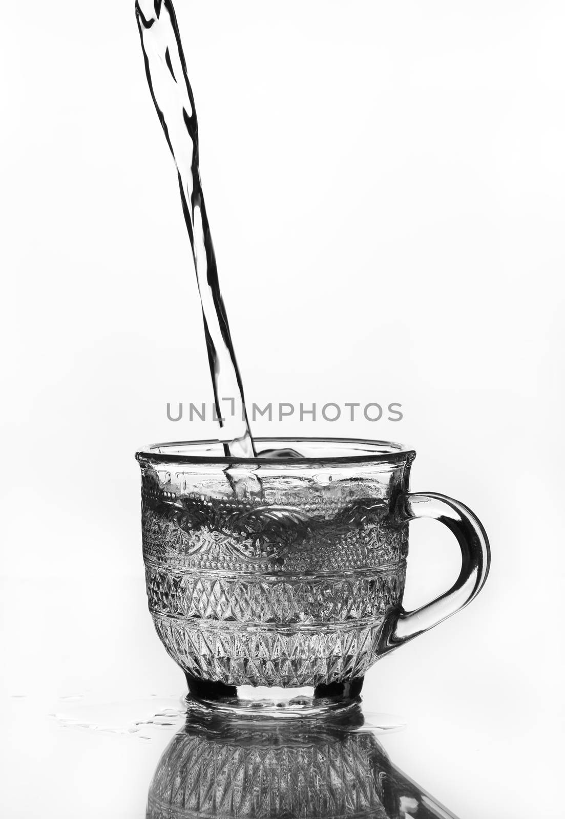 cup glass with water pouring (gray scale)