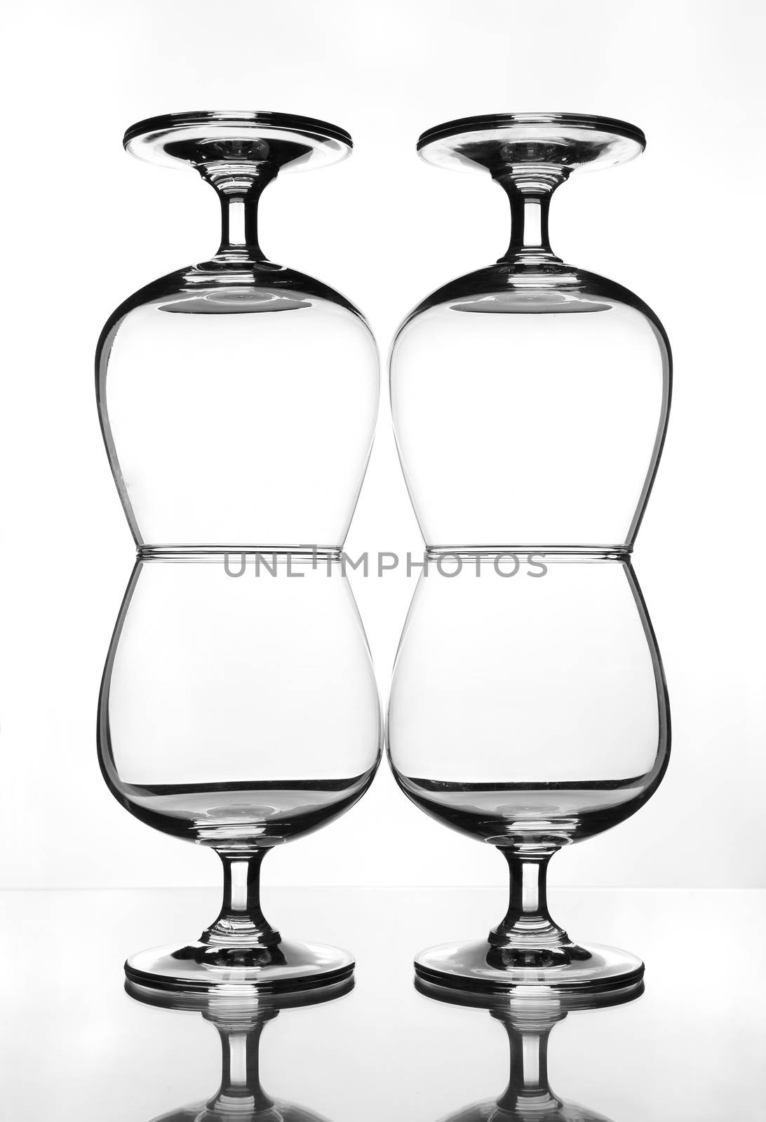 stack of empty wine glass on glass table (gray scale)