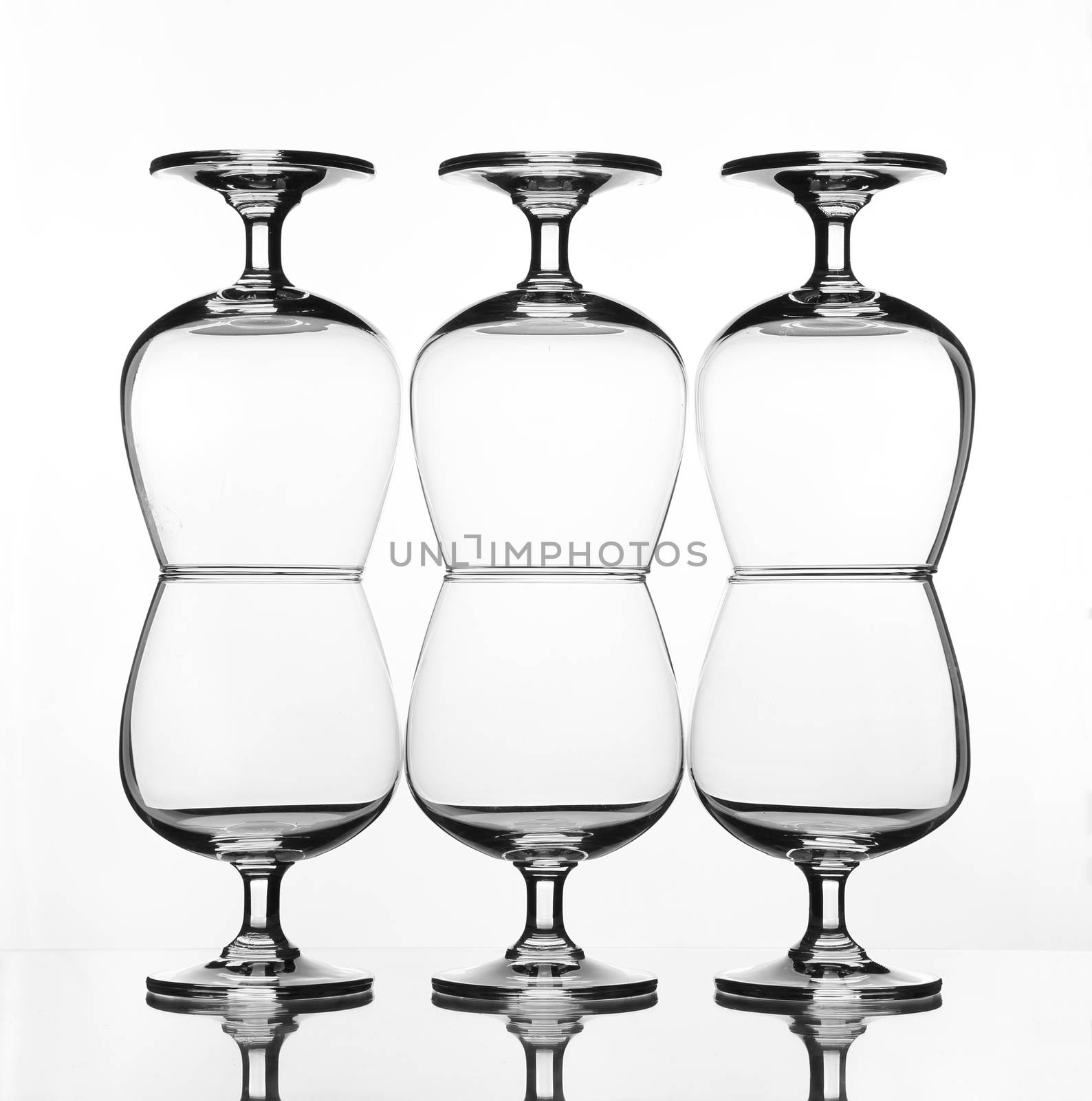 stack of empty wine glass on glass table (gray scale)