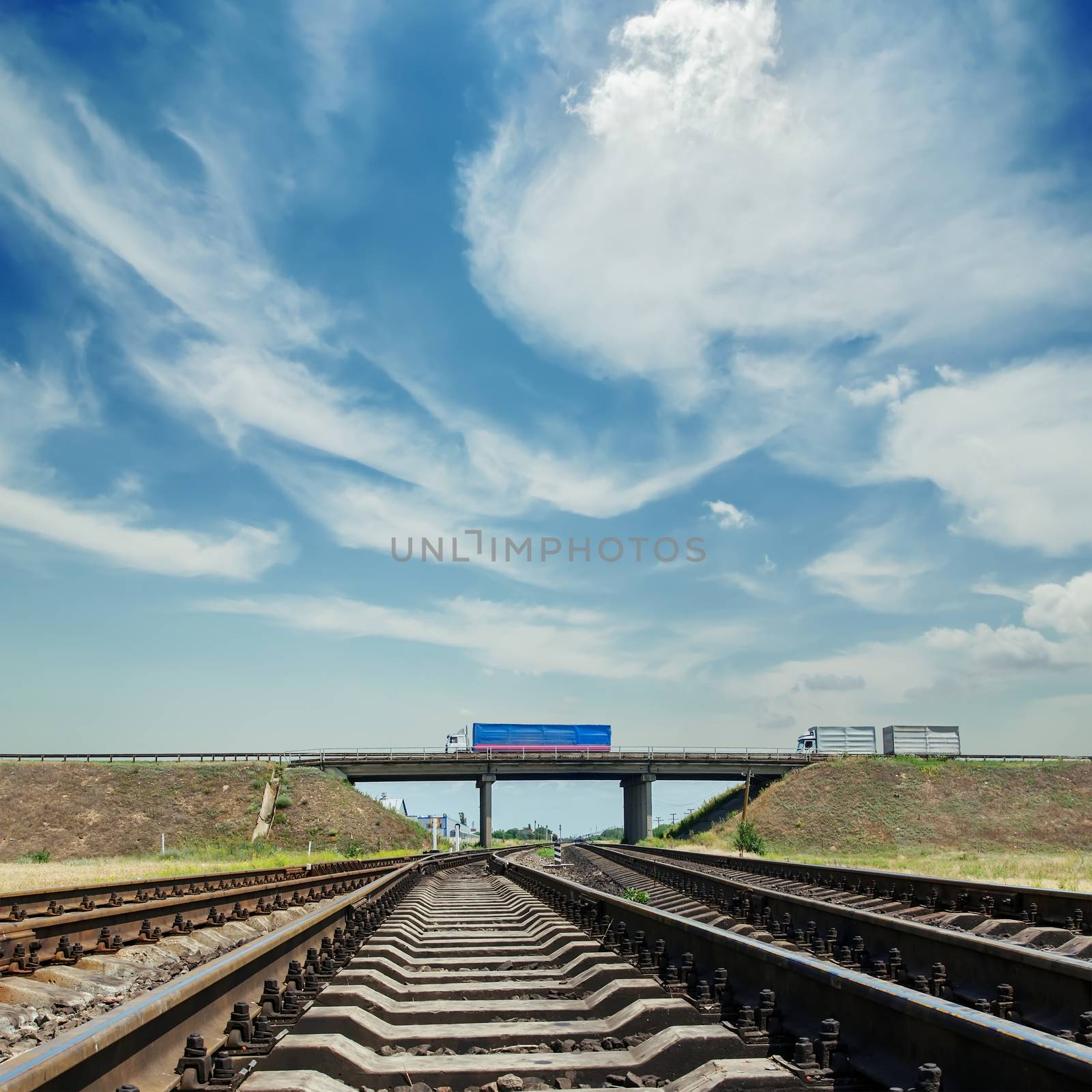 crossing of railroad to horizon and bridge with car over it by mycola
