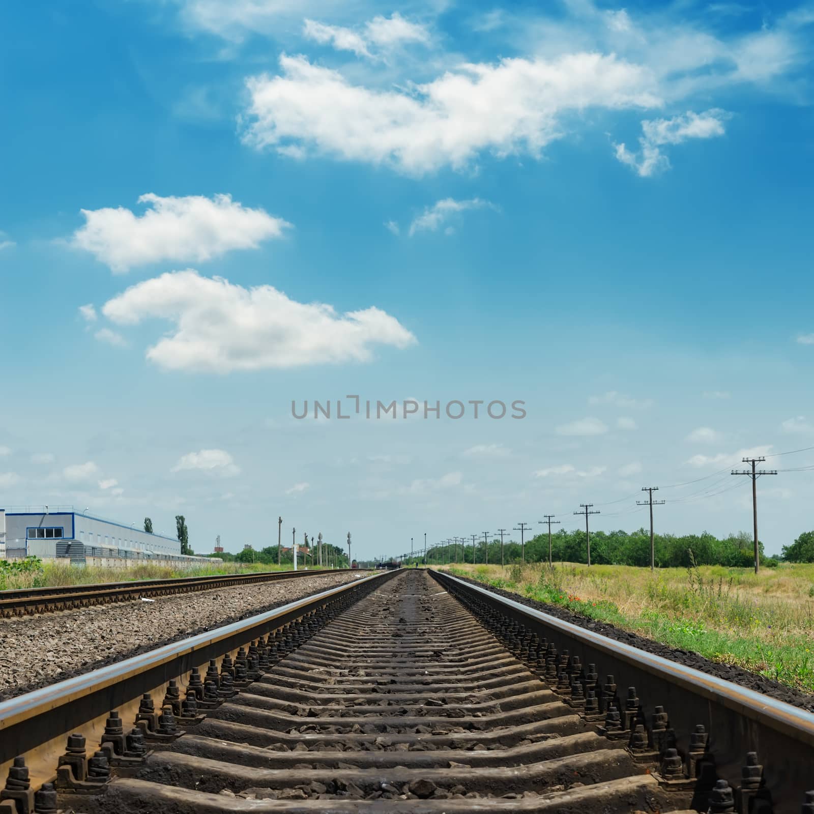 railroad closeup and clouds in blue sky by mycola