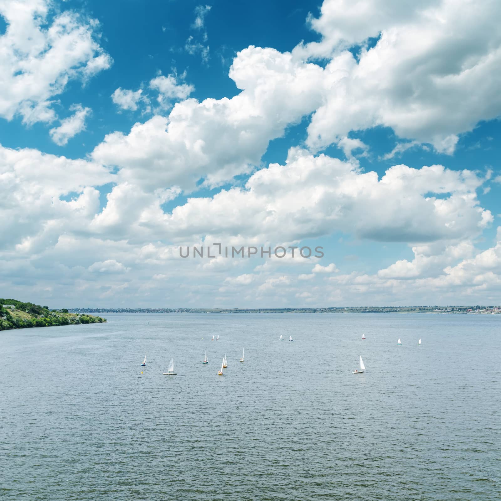 river with white yachts and cloudy sky by mycola
