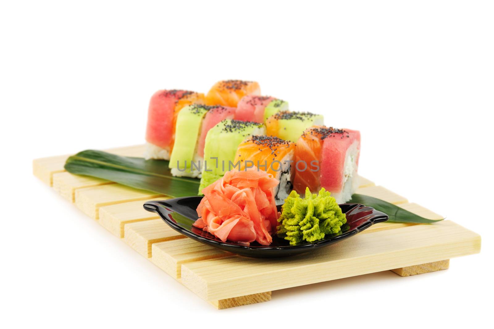 Rainbow sushi at wooden plate, isolated on white