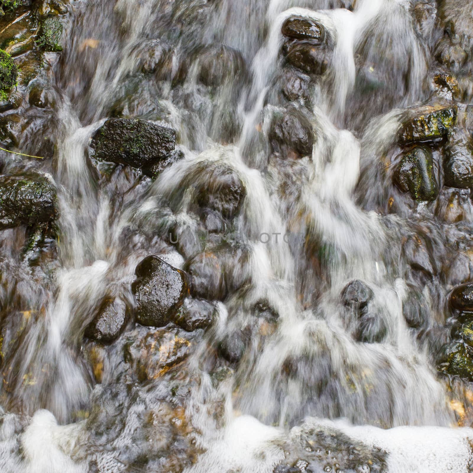 Water flowing over stones by michaklootwijk