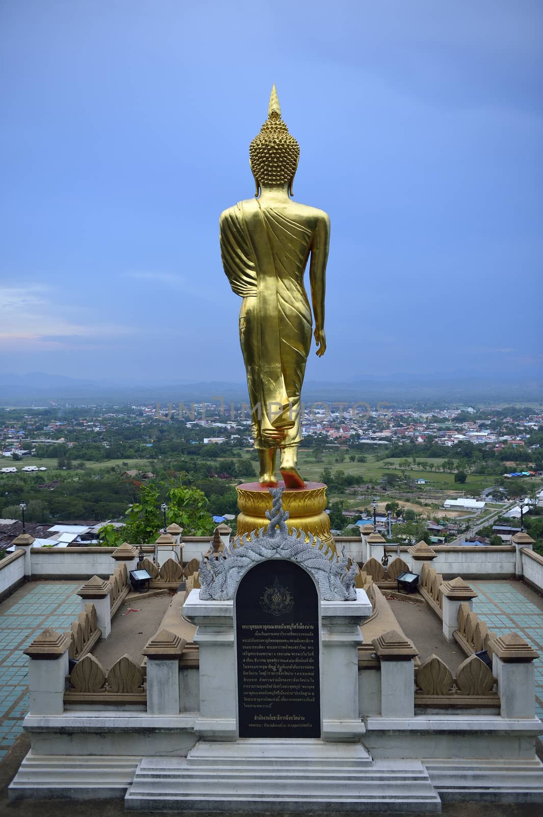 Buddha standing on a mountain Wat Phra That Khao Noi, Nan Provin by think4photop