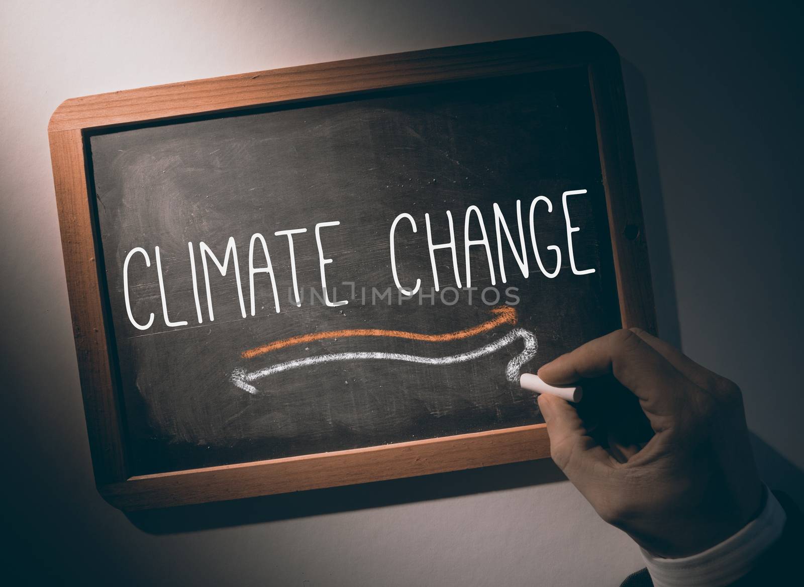 Hand writing Climate change on chalkboard by Wavebreakmedia