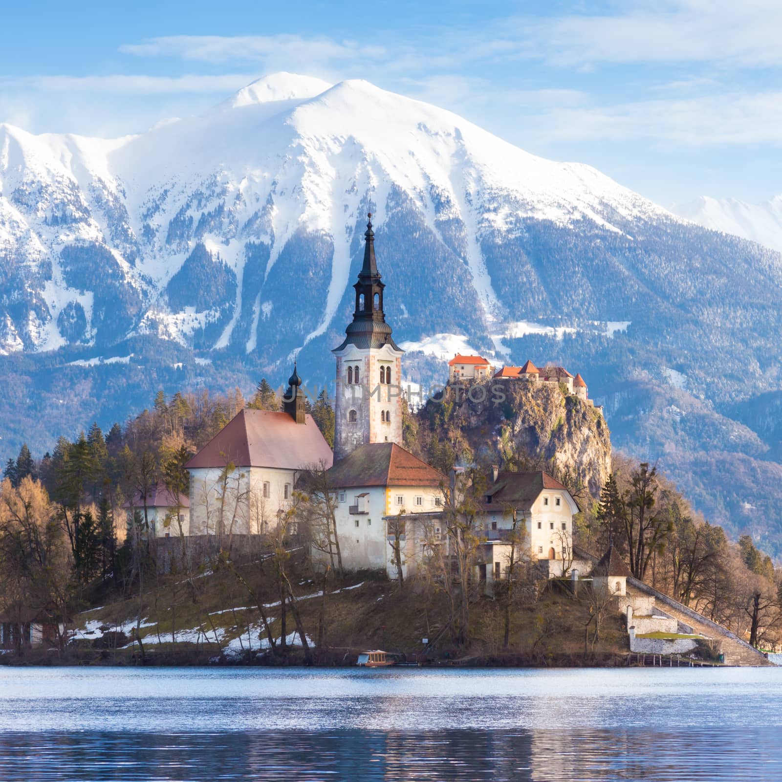Panoramic view of Julian Alps, Lake Bled with St. Marys Church of the Assumption on the small island; Bled, Slovenia, Europe.