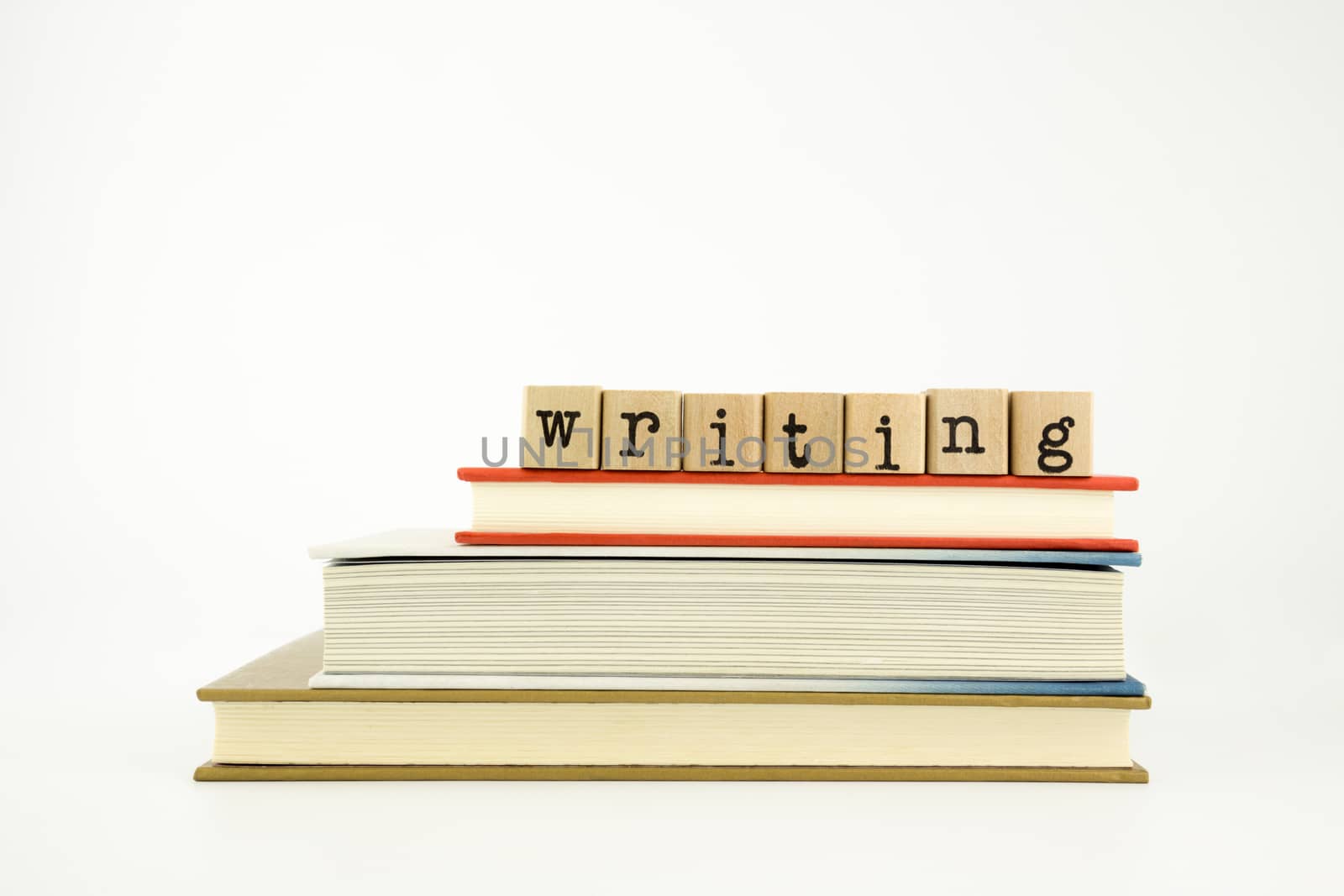 writing word on wood stamps stack on books, study and academic concept