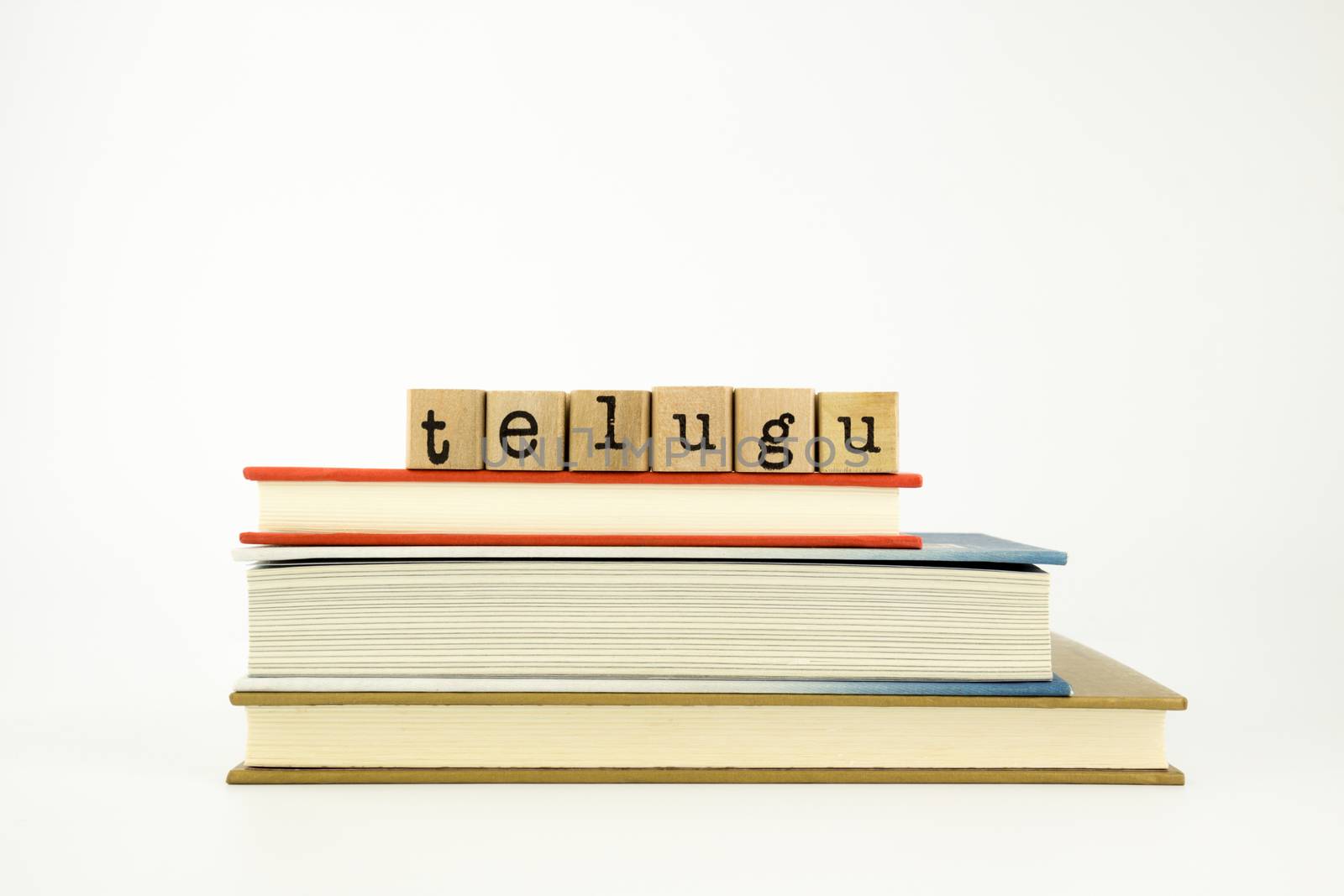 telugu word on wood stamps stack on books, conversation and translation concept