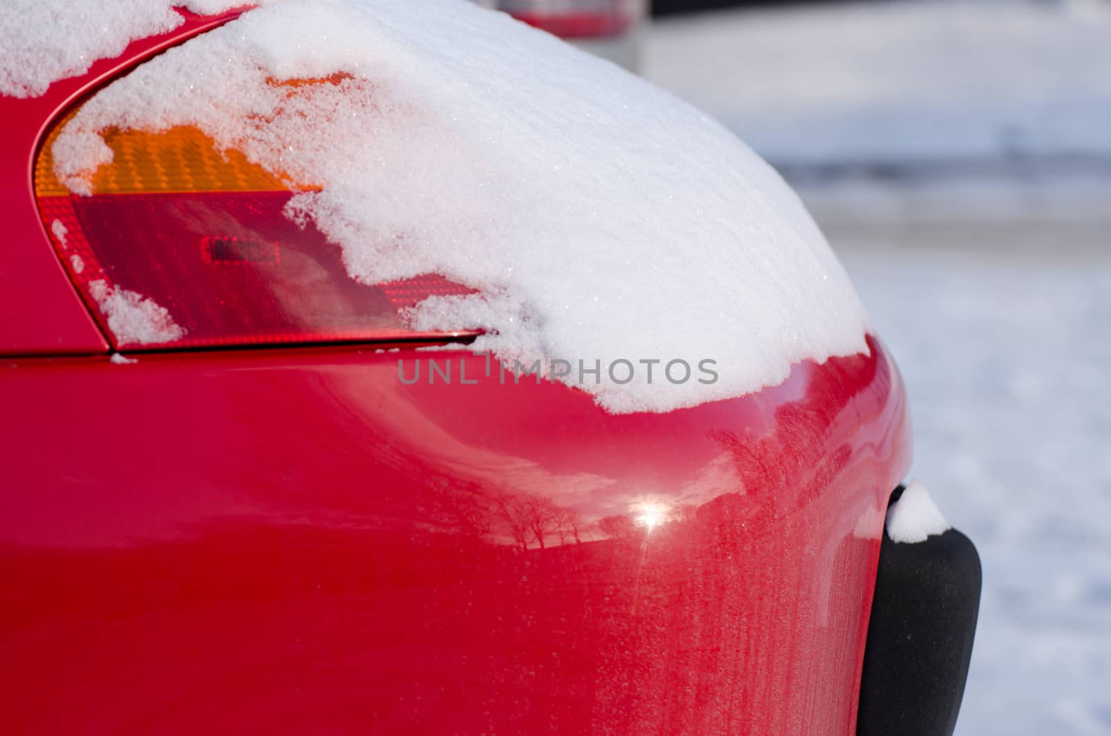 car front lamp covered with snow in winter weather by sauletas