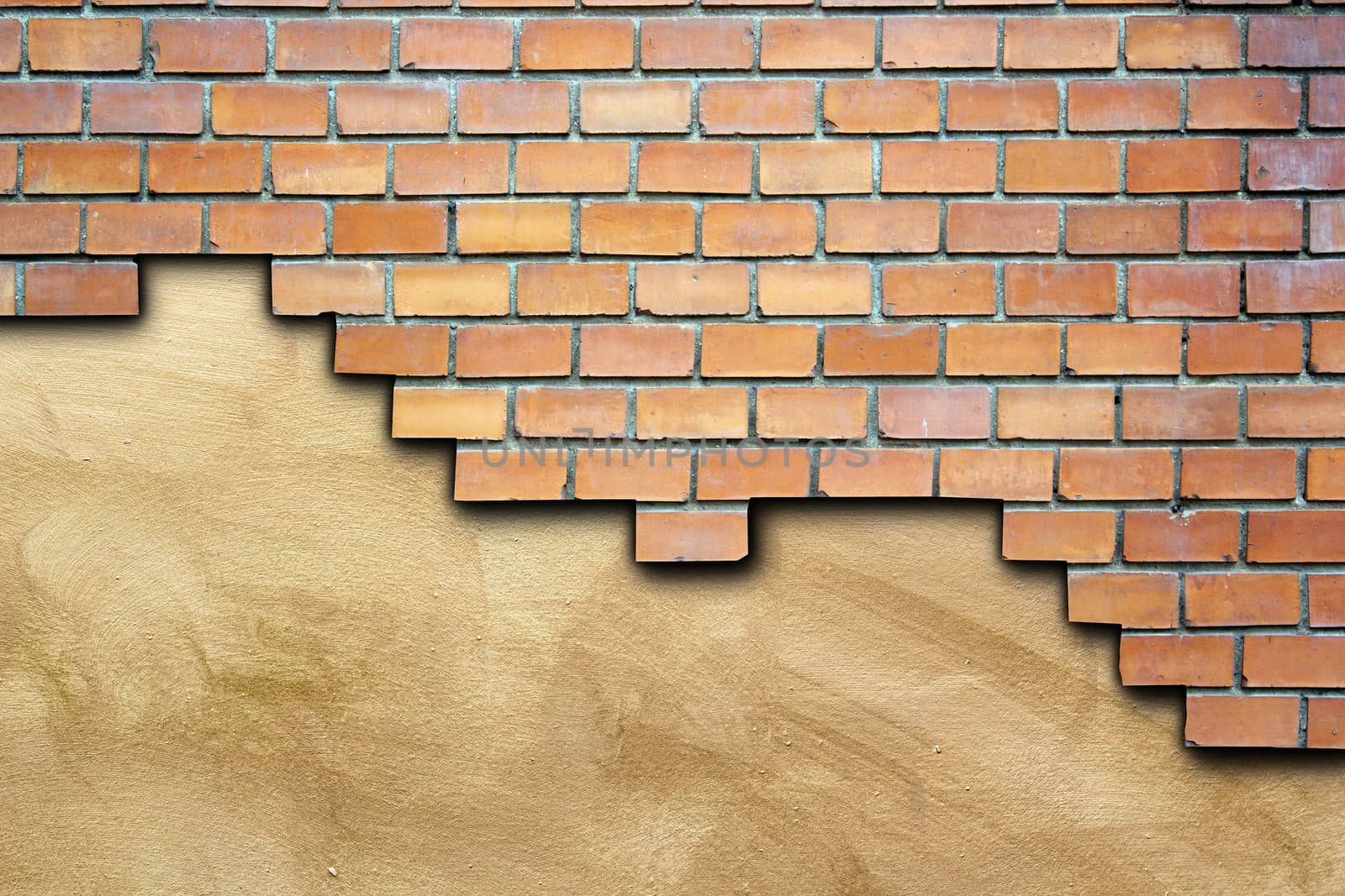 cracked surface of brick wall  revealing brown plaster