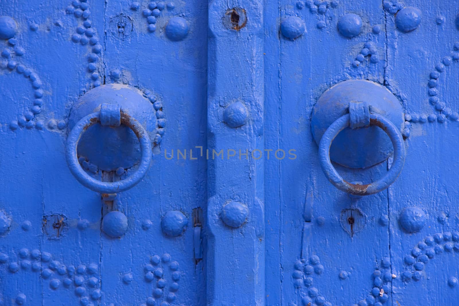 Oriental beautiful blue knocker and traditional door in Sidi Bousaid, Tunisia.