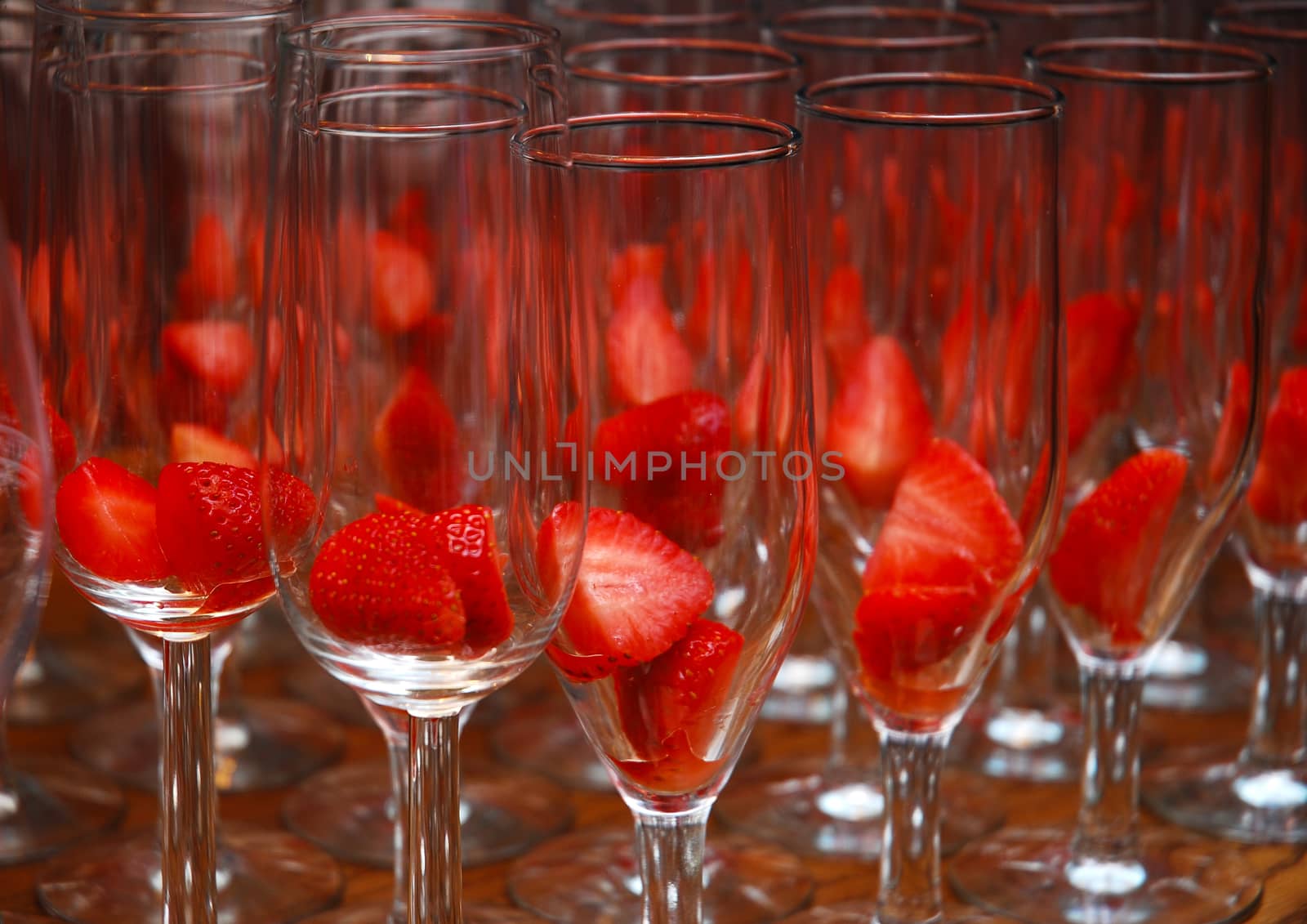 narrow glass champagne with red strawberries