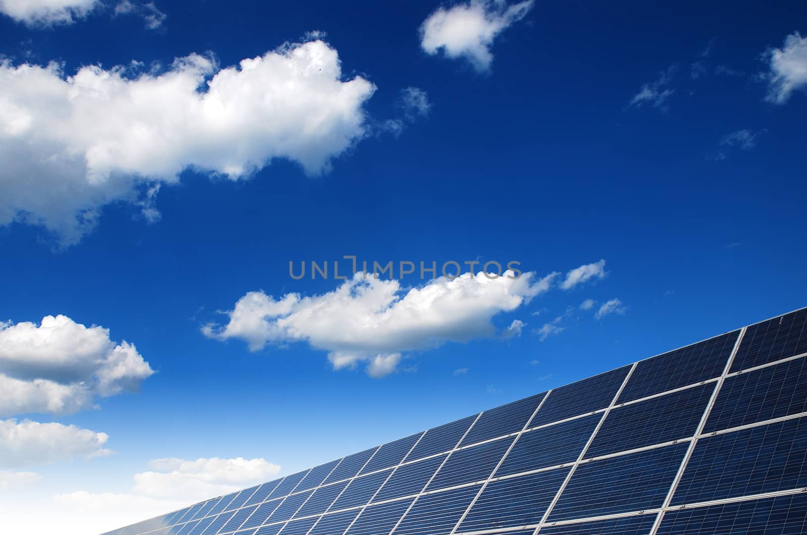 solar power station under blue sky, panels producing electricity