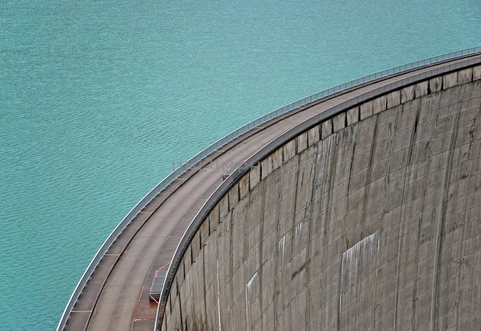blue water tank with a concrete dam