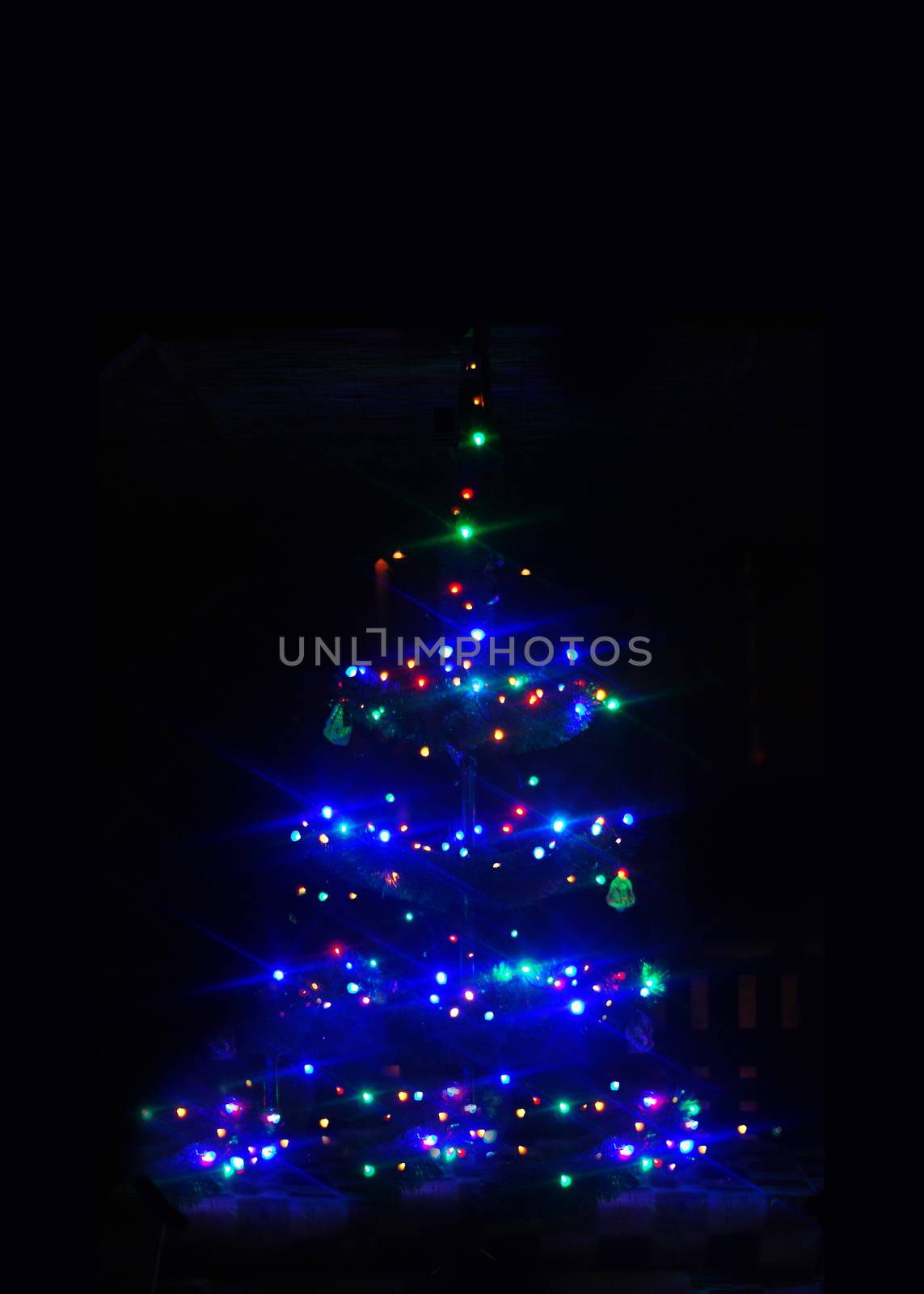 colorful strings of Christmas tree lights on the black background