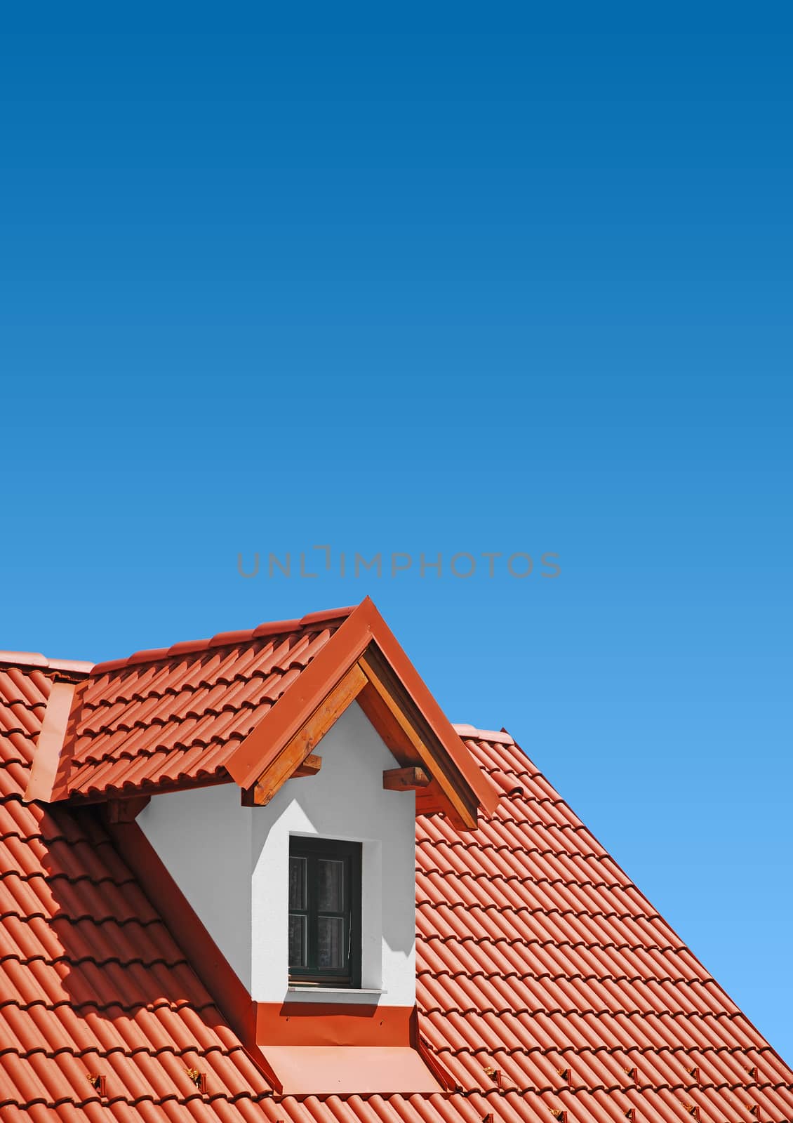 roof with red tiles on a background of blue sky, new roof