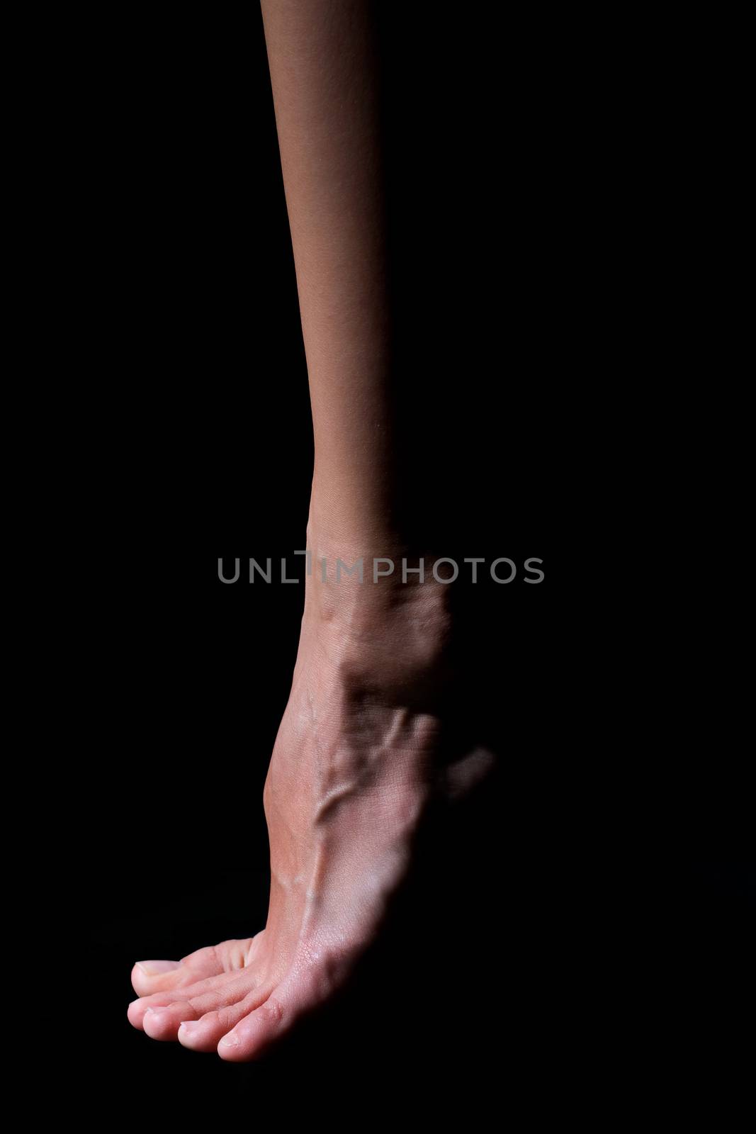 Bare foot on a black background by aniad