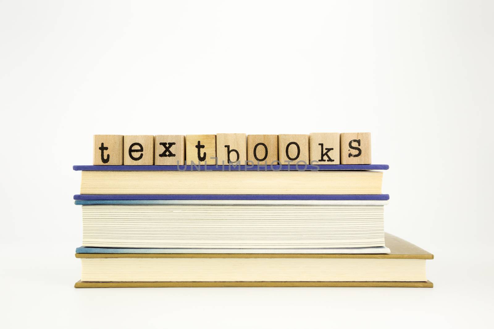 textbooks word on wood stamps stack on books, academic and study concept