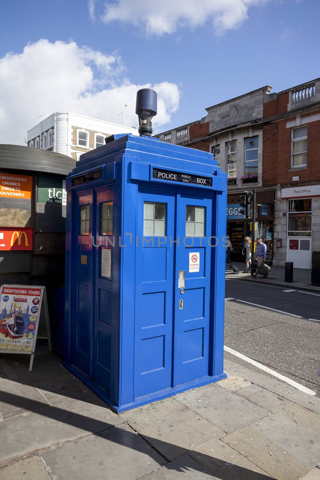 LONDON - JUNE 11, 2014: Public call police box with mounted a modern surveillance camera near Earl's Court tube station in London.