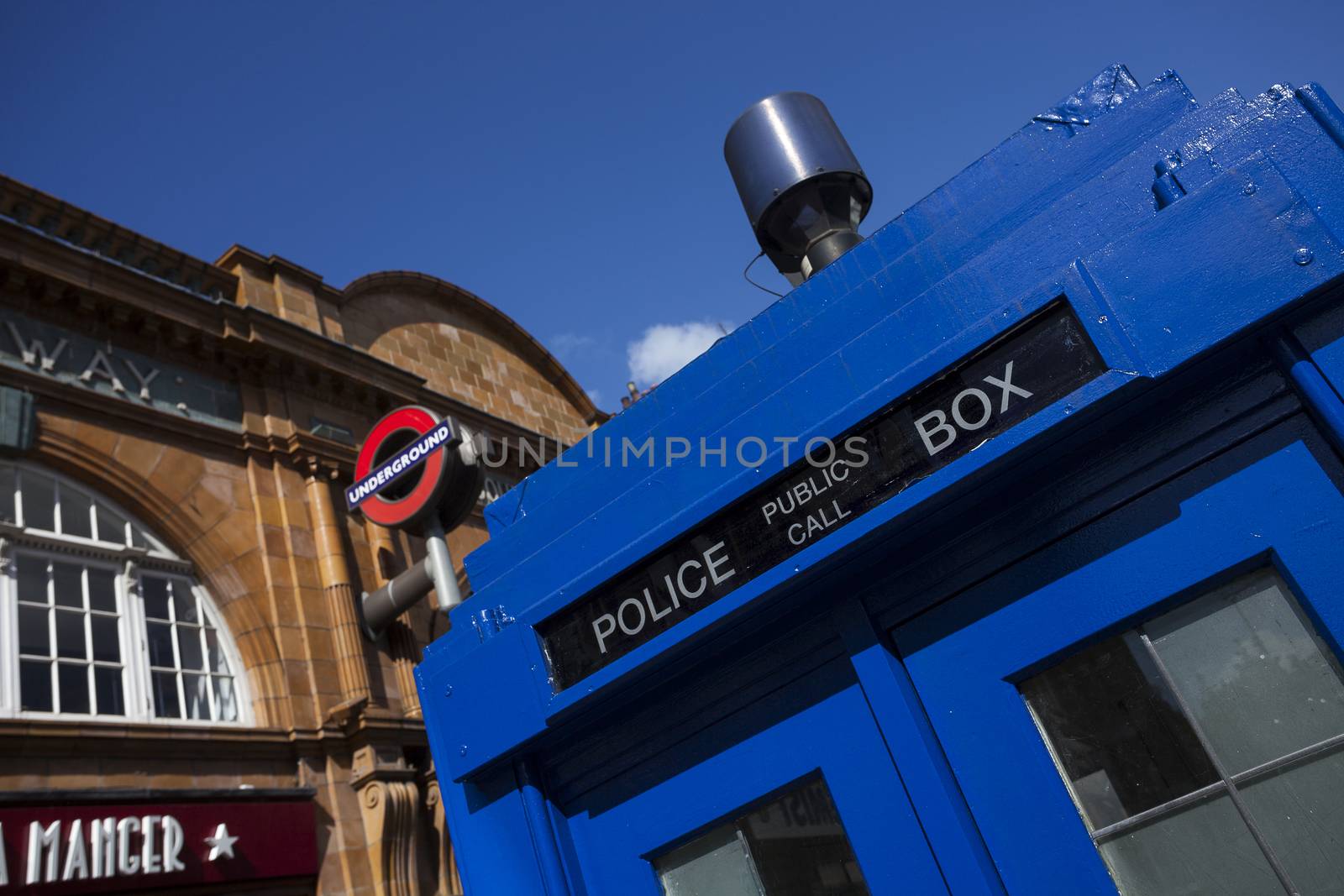 LONDON - JUNE 11, 2014: Public call police box with mounted a modern surveillance camera near Earl's Court tube station in London.