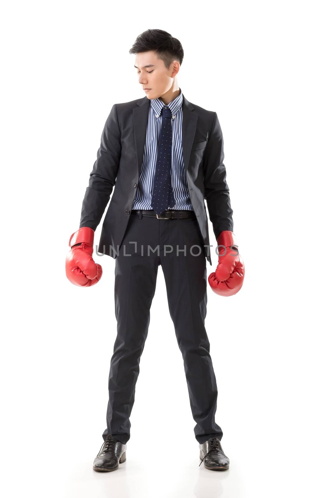 Asian businessman with boxing gloves, full length portrait isolated on white background. Concept about fight, struggle, against etc.