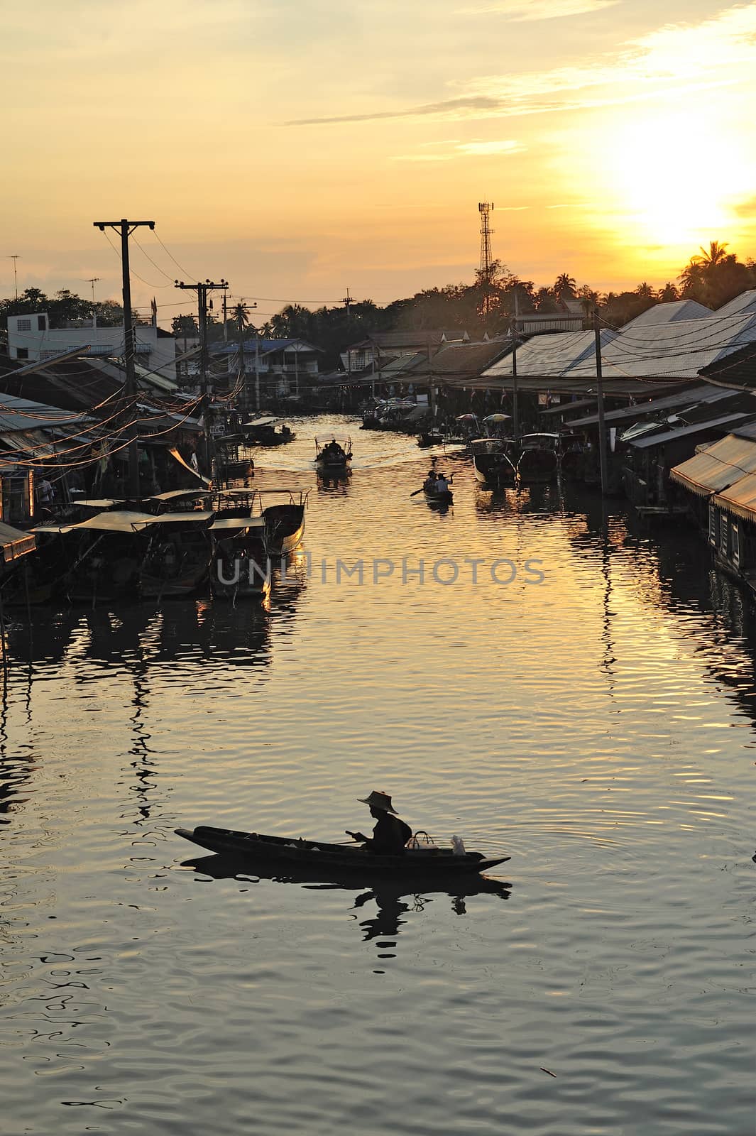 sunset at ampawa floating market, Samut songkram, Thailand. by think4photop