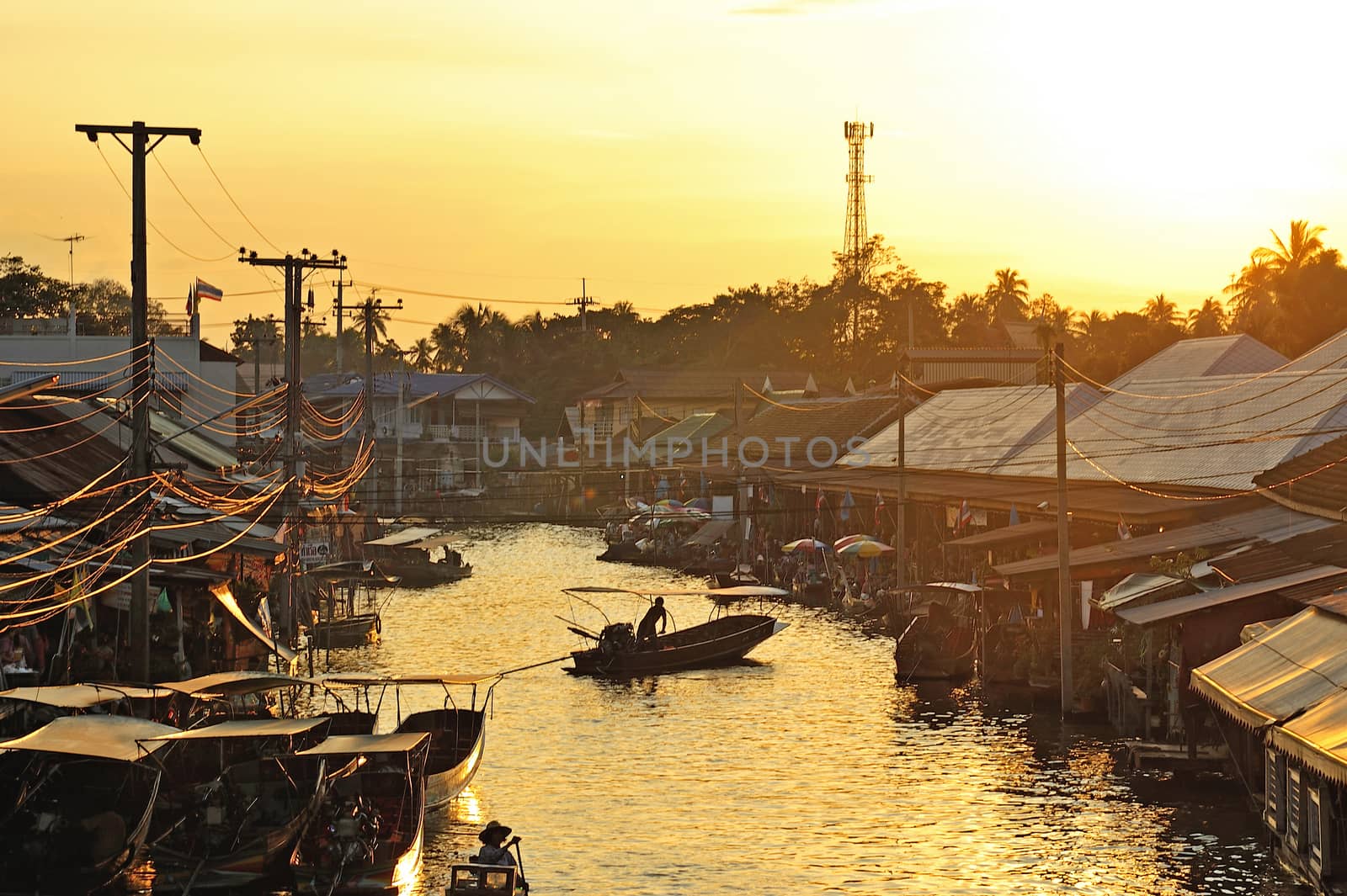 sunset at ampawa floating market, Samut songkram, Thailand. by think4photop