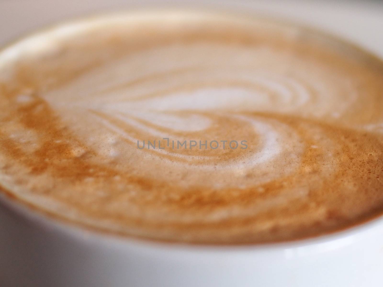 Heart drawing on latte art coffee by stockyimages