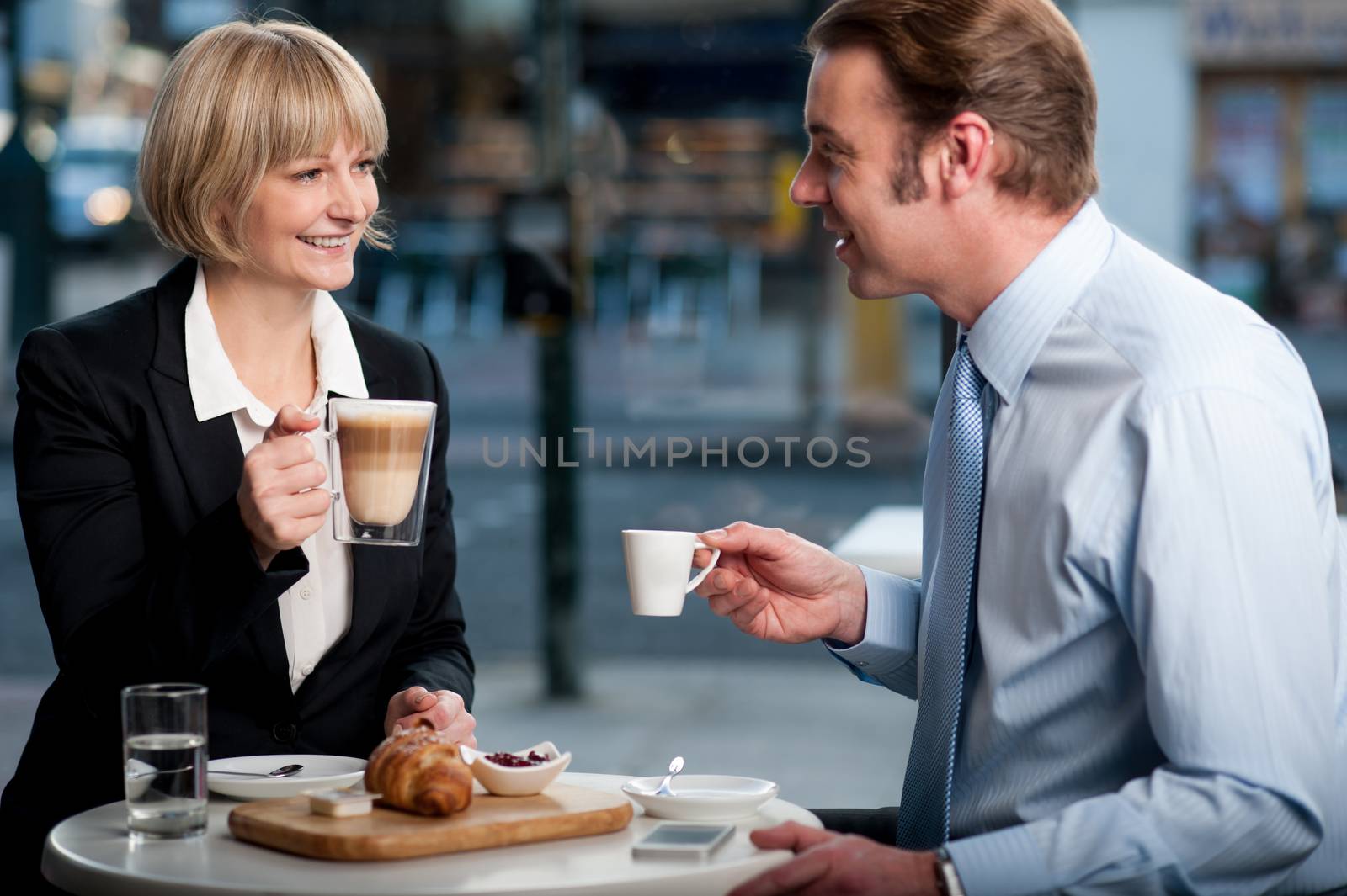 Corporate people toasting coffee at cafe by stockyimages