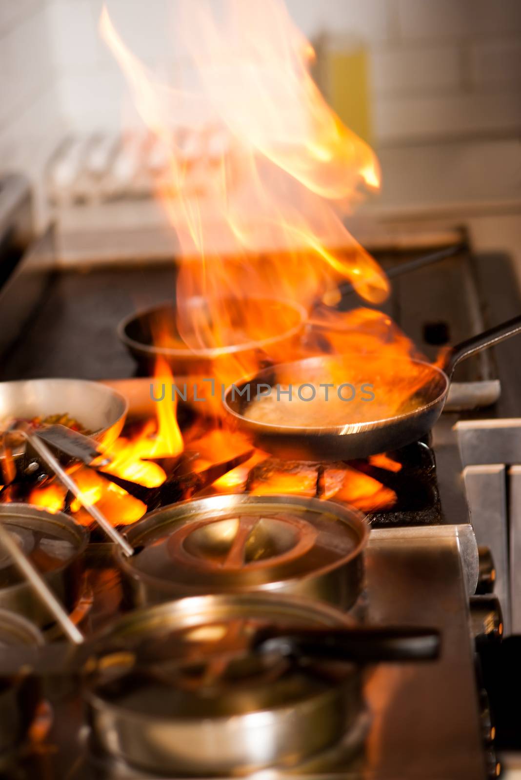 Chef cooking in kitchen stove by stockyimages