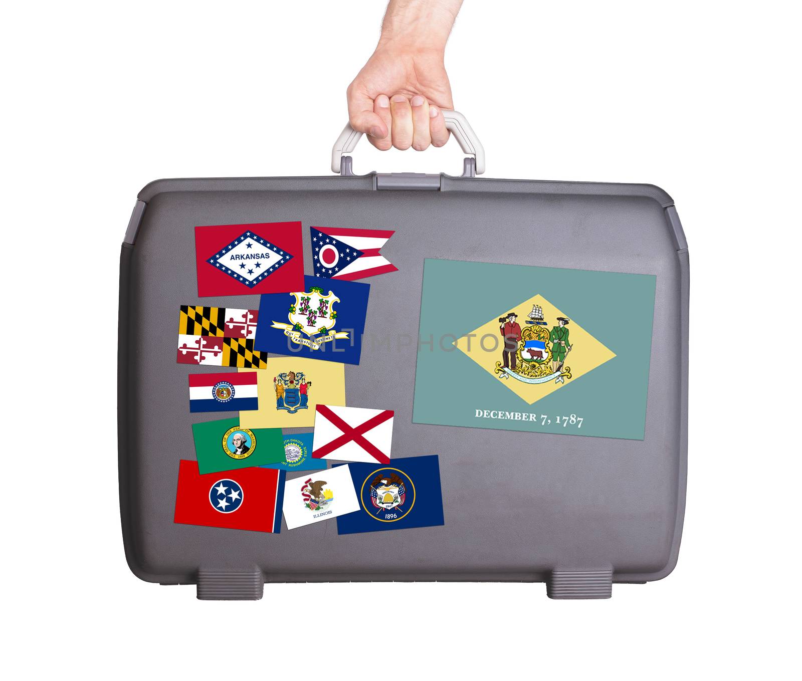 Used plastic suitcase with stains and scratches, stickers of US States, Delaware