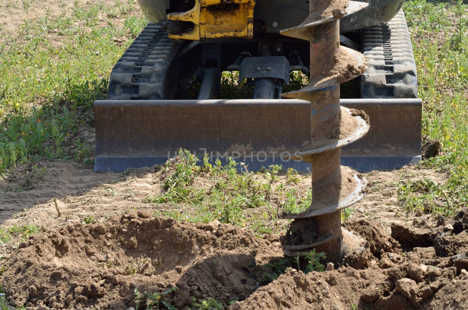 Construction drill with digger