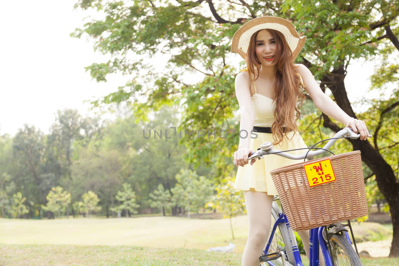 Woman riding a bicycle In the park Trees and peaceful