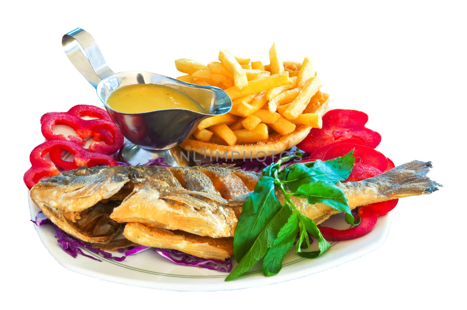 Fried carp with vegetables, potatoes and sour-sweet sauce against a white background 